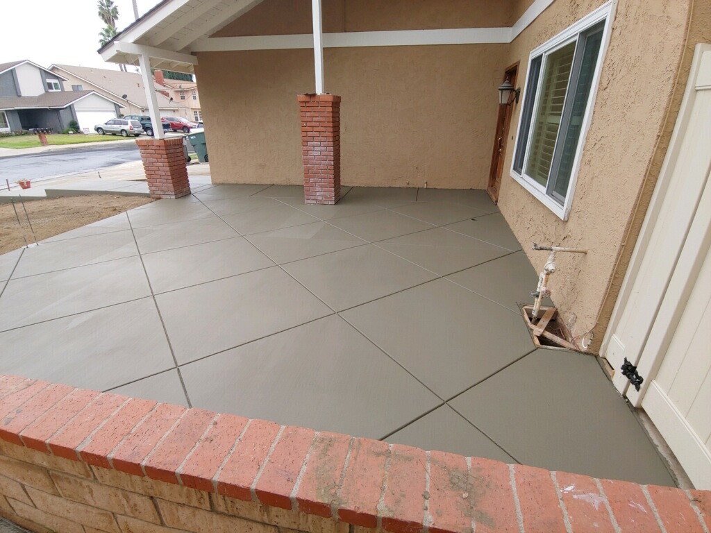 new concrete custom front patio with diagonal grid lines