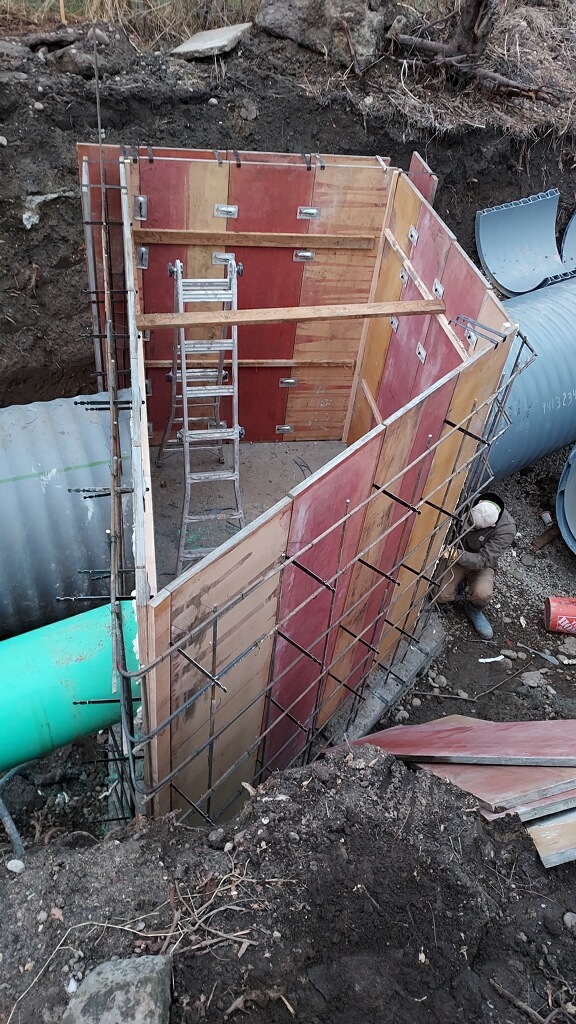 concrete worker is framing around a very large culvert