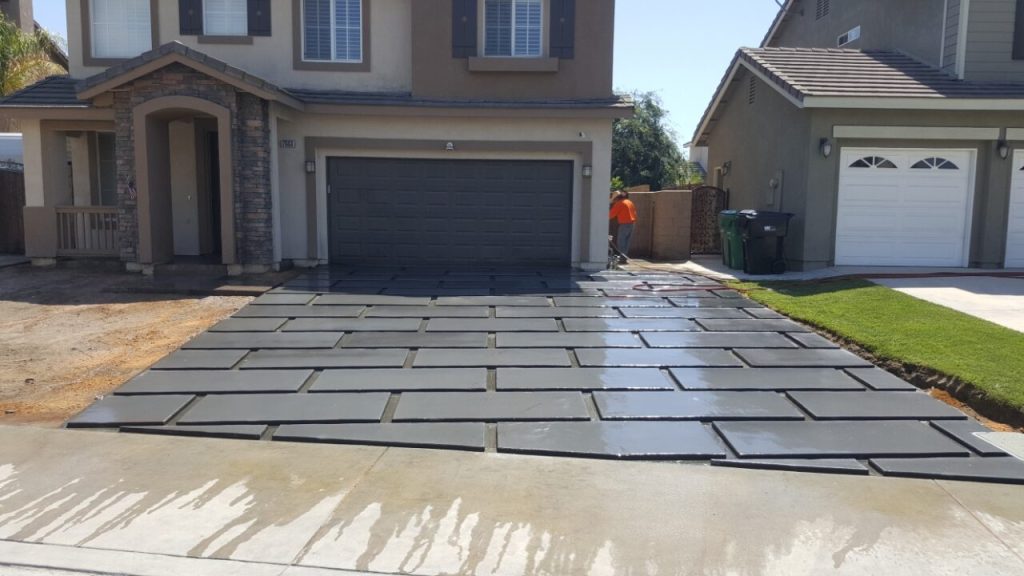 new custom concrete driveway with large rectangular pavers